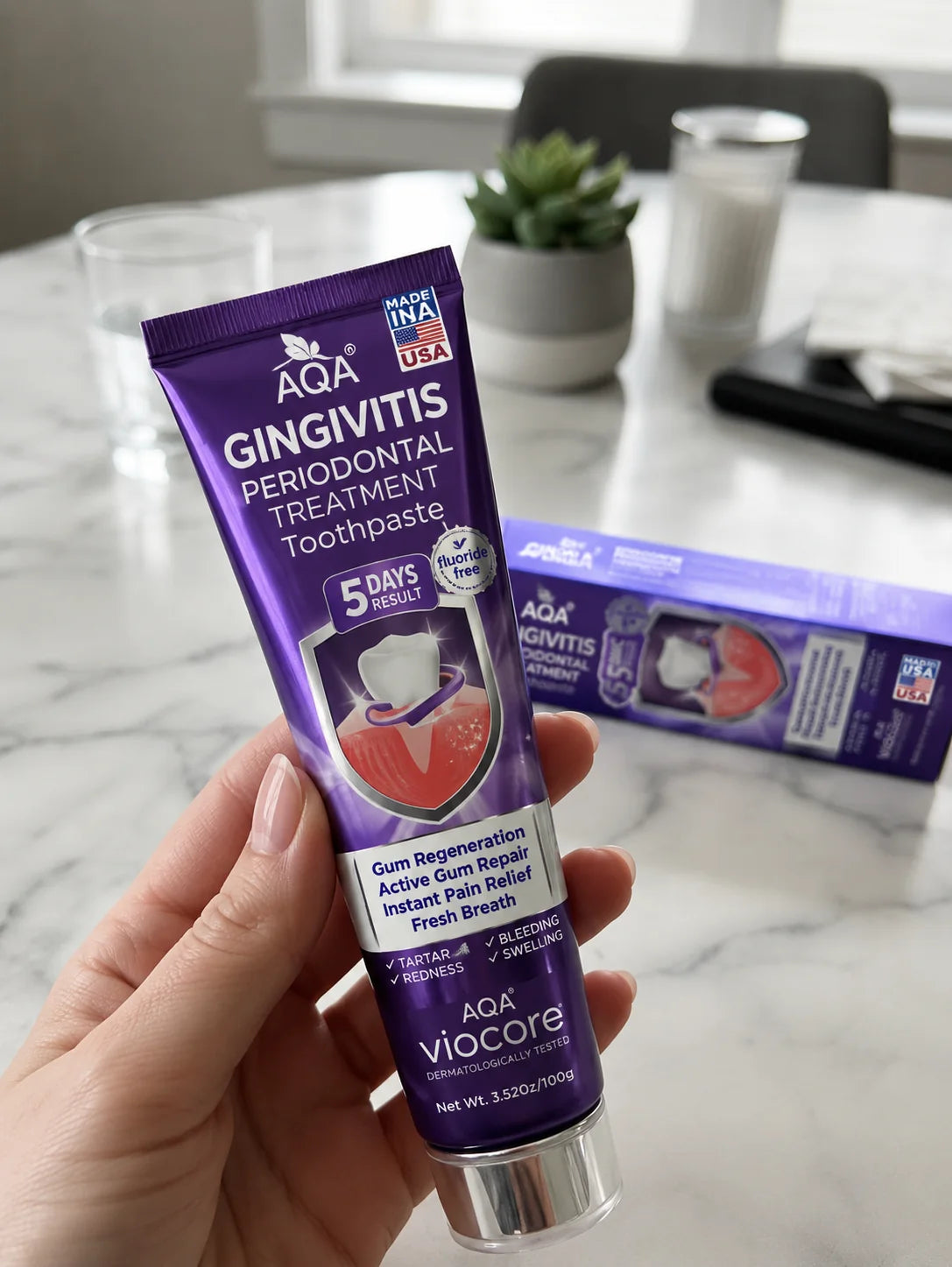 AQA VioCore toothpaste held beside the product box